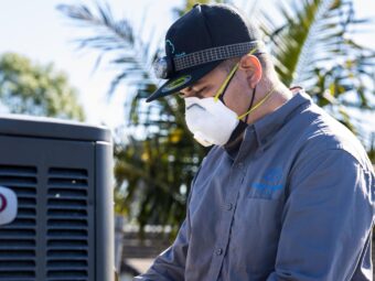 An expert is installing air conditioner